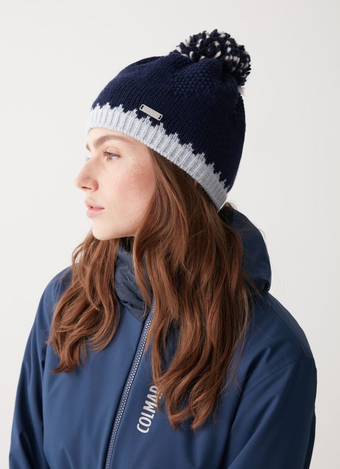 Hat with contrasting trim and pom-pom